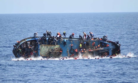 Migrants  fall into the sea from a boat that capsized last week as Italian navy ships attempted a rescue
