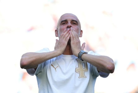 Pep Guardiola kisses his hands towards fans at the Etihad