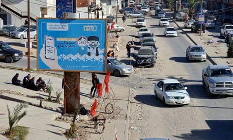 An electoral billboard in Tripoli reading in Arabic 'register and vote before missing your chance'