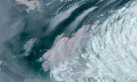 In this GOES-16 GeoColor and fire temperature satellite image taken Tuesday, June 6, 2023 at 6:40 p.m. EDT and provided by CIRA/NOAA, smoke from wildfires burning in the Canadian Provinces of Quebec, center, and Ontario, left, drift southward.