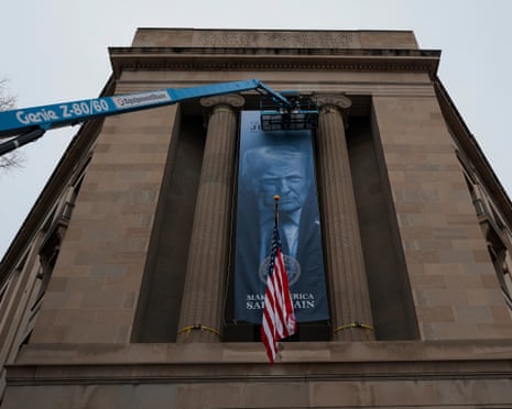 A banner of president Donald Trump is hung on the Department of Justice on 19 February.