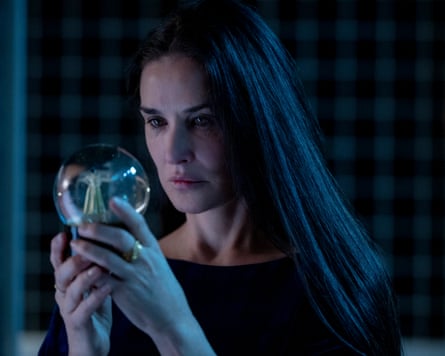 Demi Moore stars into a glass snow globe.