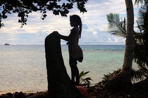 A young girl looks out onto the Funafuti lagoon