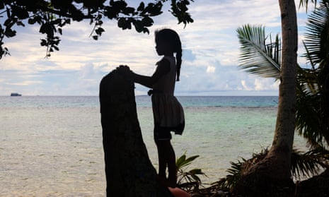 A young girl looks out on to the Funafuti lagoon in Tuvalu, a country that is extremely vulnerable to the climate crisis. 