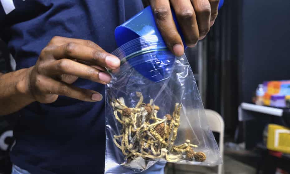 A vendor bags psilocybin mushrooms at a cannabis marketplace in Los Angeles in May 2019. Oakland City Council voted Tuesday to decriminalize the possession and use of entheogenic, or psychoactive, plants and fungi.