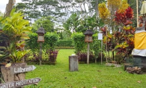 Garden area and signpost to a sacred labyrinth at Bali Silent Retreat, Bali.