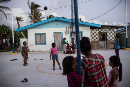 Children play volleyball in Majuro where the minimum wage is $2 and half the population is under 24.