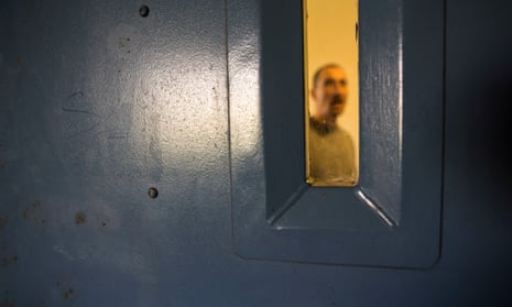 An inmate at a cell door window in HMP Portland