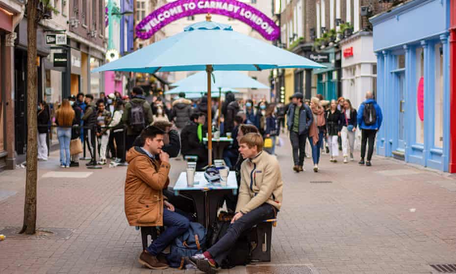 People enjoying food and drinks in Carnaby Street area of London
