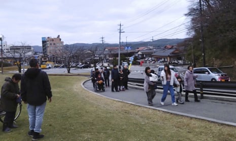 People walk to higher ground in Wajima, Ishikawa.