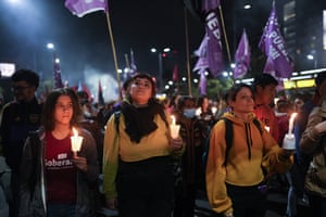 Women hold candles to honour Perón