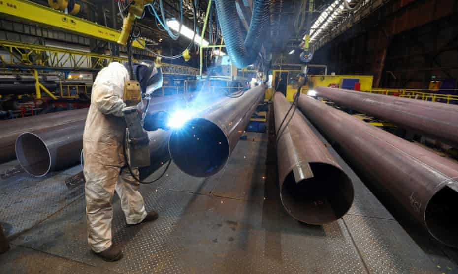 A worker welds a joint on a steel pipe at a factory operated by Liberty Commodities in Hartlepool.