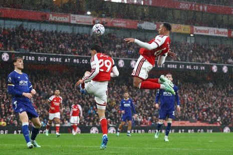 Arsenal’s Gabriel Magalhaes leaps to head the ball during a rainy match against Everton