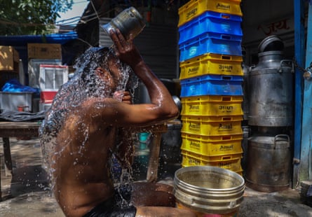 A man pouring water over his head outside