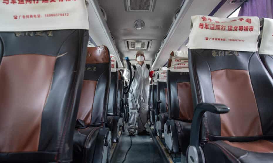 Disinfectant is sprayed on a bus in Wuhan, Hubei