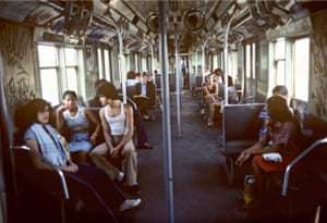 a Willy Spiller photo titled "A Train to Brighton Beach, 1977", showing people sitting on a NYC subway train on a sunny day