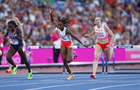 Poland's Pia Skrzyszowska crosses the line to win her women's 100m hurdles semi-final ahead of second placed Great Britain's Marcia Sey (left) and third placed France's Laeticia Bapte (centre).