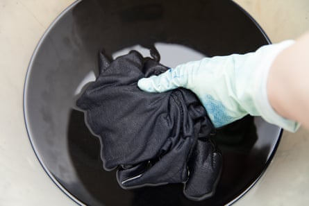 When over-dying black clothes, wear gloves and use a seperate tub or pot, so you do not dye your sink or bathtub in the process.
