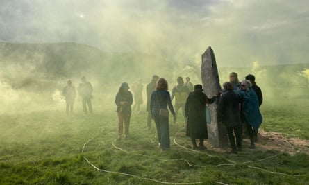 Revellers at the Gurdy Stone surrounded by green mists.