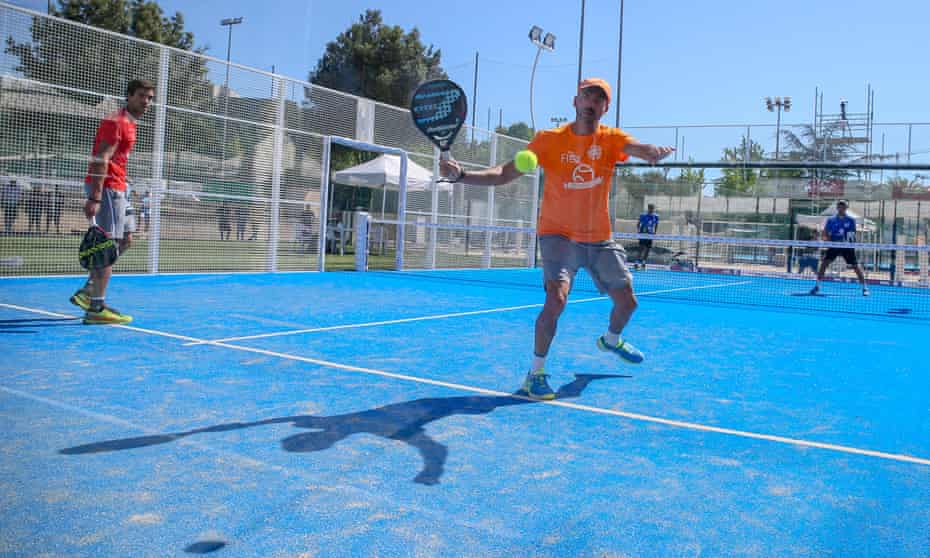 a game of padel played on a padel court