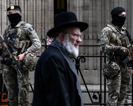 Two armed military personnel outside a synagogue