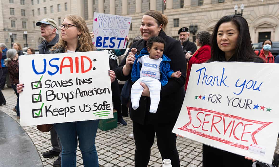 USAid supporters hold banners including one reading 'Thank you for your service'
