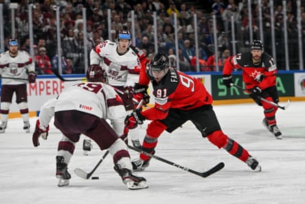 Canada’s Adam Fantilli takes on a defenseman during Saturday’s semi-final against Latvia.