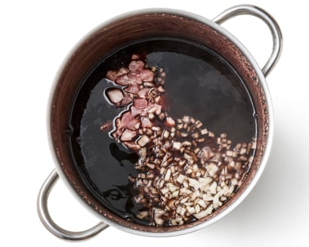 onion and bacon added to the pan of beans