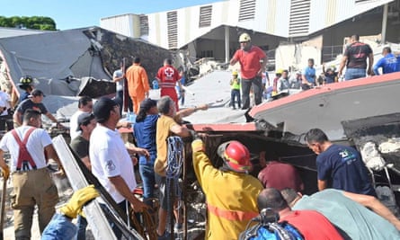 Rescue workers search for survivors amid debris after the roof of a church collapsed.