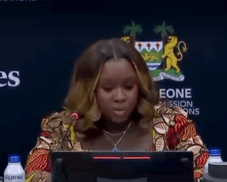An African woman speaking at a lectern