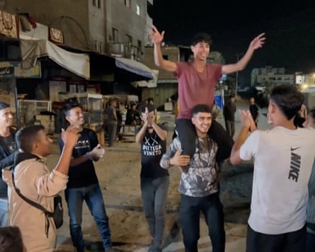 Palestinians celebrate on a street in Khan Younis following the news.