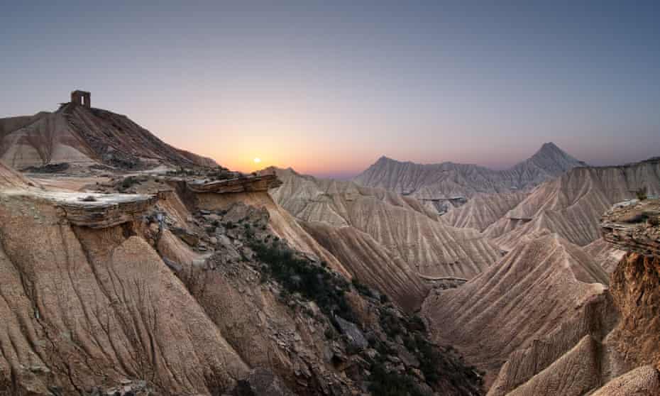 The sunset amid the mountainous and desert-like landscape at Bardenas Reales natural park in Navarra, northern Spain