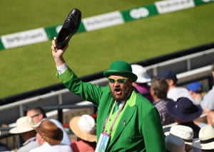 An Ireland fan celebrates runs by waving his shoe.