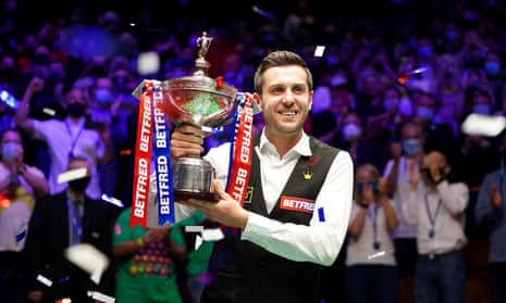 Mark Selby grasps the trophy after adding the 2021 world snooker title to his 2014, 2016 and 2017 victories at the Crucible.