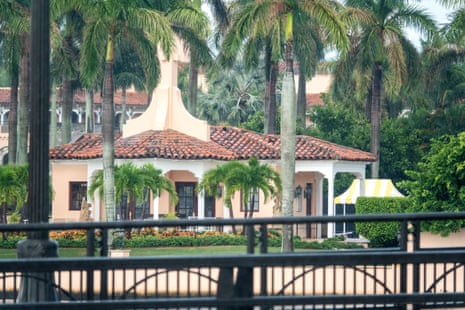 The pink Mar-a-Lago resort is surrounded by a black security fence.