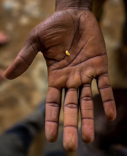 a hand with a gold nugget in the palm