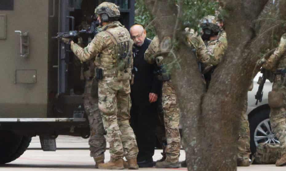 Authorities escort a hostage out of the Congregation Beth Israel synagogue in Colleyville, Texas, US.