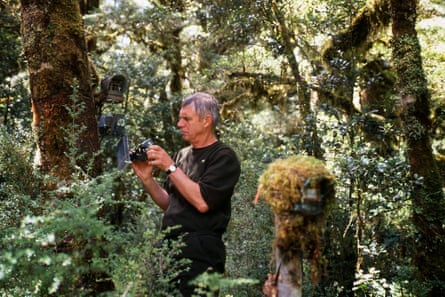 Ken Tustin servicing trail cameras in the Fiordland bush.