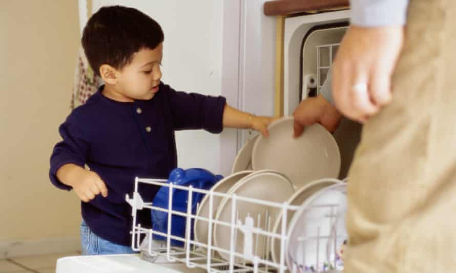 Toddler helping unload dishwasher