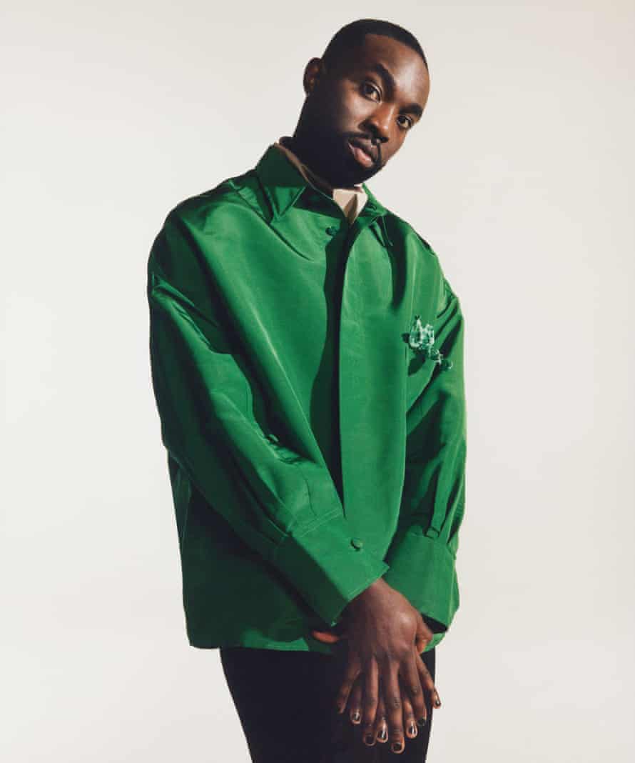 Actor Paapa Essiedu in bright green jacket and black trousers