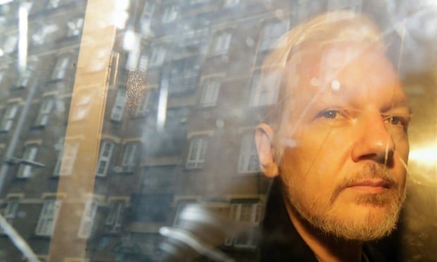 Julian Assange is taken from court in London in May 2019.