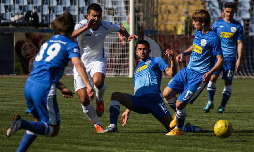 A Tavria player (in white) fights for the ball during a 2015 home cup match with SKChF Sevastopol at the Lokomotiv stadium in Simferopol.