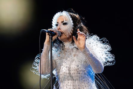 a woman sings on stage