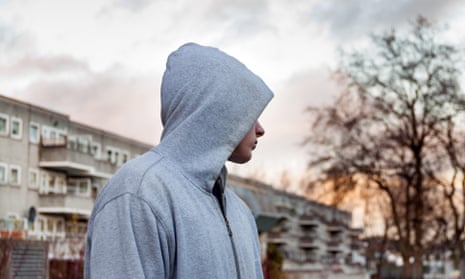 Teenager hanging around wearing hoodie top.