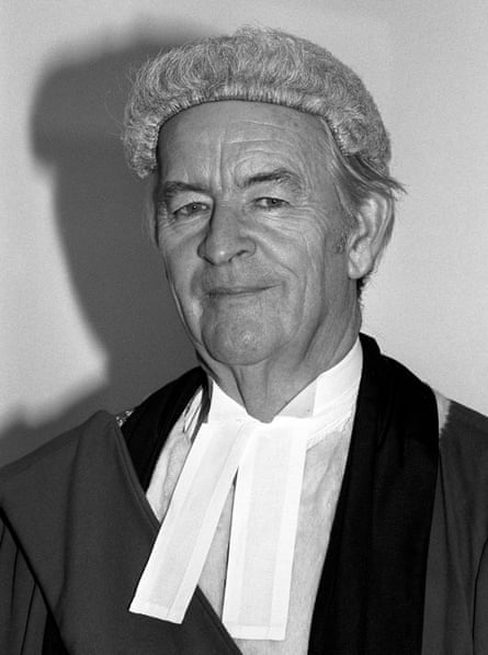 A black and white image of a judge wearing a wig and a black top and white shirt