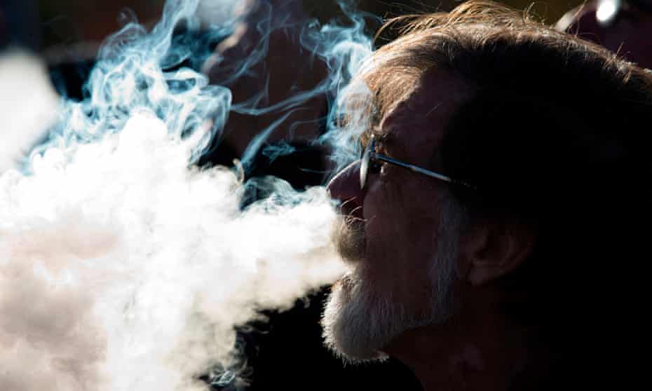 A man smokes an e-cigarette