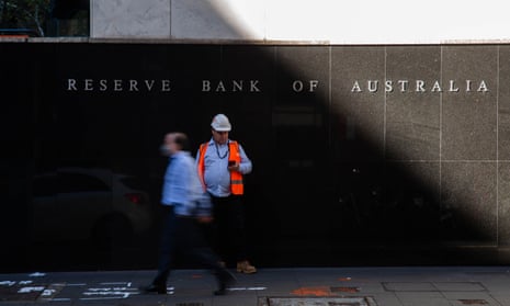 Two workers stand outside the Reserve Bank of Australia office