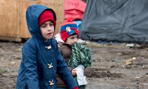 Migrant children play in the southern part of the so-called 'Jungle' migrant camp, on March 2, 2016.