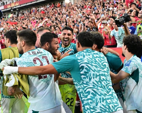 Gonçalo Ramos is swamped by teammates after scoring the winning goal in added time for Portugal.