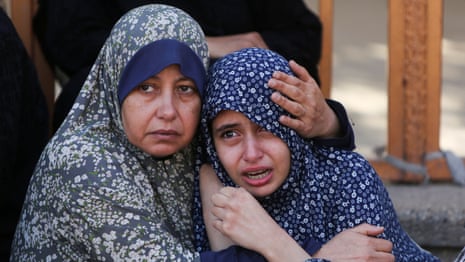 People in the aftermath of people being shot at waiting for food near an aid distribution site in Rafah.